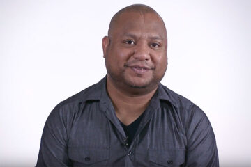 african American male talking to the camera on white background